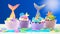 Mermaid theme cupcakes with colorful glitter tails, shells and sea creatures.