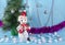 Merry adventures of a snowman under a green tree on new year`s eve on a blue decorated stage