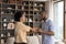 Merry African couple in love dancing in living room