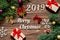 Merry Christmas 2019. Christmas gifts and tinsel on the wooden background