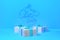 Merry Christmas 2019 lettering written on blue color wall and three present gift boxes with bows beside. 3d illustration