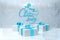 Merry Christmas 2019 lettering written by blue ribbon on ice snowy wall and three present gift boxes with bows beside