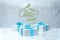 Merry Christmas 2019 lettering written by red and green striped ribbon on ice snowy wall and three present gift boxes