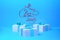 Merry Christmas 2019 lettering written in trendy blue color wall and three present gift boxes with bows beside. 3d