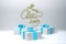 Merry Christmas 2019 lettering written in white color wall and three present gift boxes with bows beside. 3d