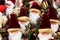 Merry Christmas background with many Santa Claus decorative figures in funny Irish suits with presents and toys for kids