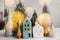 Merry Christmas. Christmas little houses and trees with golden lights bokeh on white background. Festive modern decor. Happy