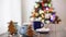 Merry Christmas! Christmas tree-shaped gingerbread cookie near cups of cocoa and marshmallows. Beautiful blurred christmas tree