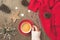 Merry Christmas concept. Coffee cup, woman hand, warm sweater and decorations on wooden background. Top view, flat lay