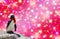 Merry Christmas concept a funny penguin wearing a shawl and santa claus bonnet isolated on a colored background with colorful star