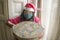 Merry Christmas during covid19 - young beautiful and happy Asian Japanese woman in  face mask and Santa Claus hat holding xmas