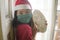 Merry Christmas during covid19 - young beautiful and happy Asian Japanese woman in  face mask and Santa Claus hat holding xmas