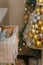 Merry Christmas decorated interior details. Drawer with shiny pine cone toy, pearl beads, artificial snow. Golden baubles,