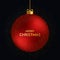 Merry Christmas greeting card. Merry Christmas phrase and red christmas ball on dark background.