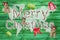 Merry christmas greetings with text on green wooden background -