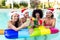 Merry christmas! happy diverse group of friends wearing xmas santa hat having drinks making a toast with cocktails on swimming