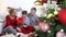 Merry christmas, happy family at home, parents give Christmas present to their surprised and curious son near the illuminated and