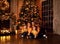 Merry Christmas and Happy Holidays. Mom Father and daughters near decorated the Christmas tree and fireplace