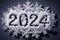 Merry Christmas and Happy New Year 2024 holiday card. Number 2024 write on snow and snowflakes. Top view