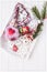 Merry Christmas and Happy New Year. Christmas tree branches and Christmas ornaments in white tray on a white background. Top view,