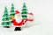 Merry Christmas and happy new year concept. Cute santa claus figure and tree on snow with copy space