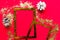Merry Christmas and Happy New Year. Flat lay photo with golden mockup photo frames and Christmas decorations on bright red backgro