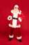 Merry Christmas and Happy New Year! Full length photo of Santa Claus with white beard looking at the camera. Xmas sale, discount