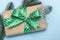 Merry Christmas and Happy New Year. Gift with a green ribbon with polka dots and ornaments on a blue background. Holiday