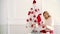 Merry christmas and Happy new year. Girl decorated Christmas tree, wearing in Christmas dress. Sensual girl for