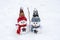 Merry christmas and happy new year greeting card with copy space Happy two little snowmen in red, blue cap and scarf standing in
