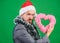 Merry christmas and happy new year. Hipster hold heart symbol of love. Bring love to family holiday. Spread love around