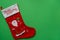 merry christmas holiday red sock, gift stocking with santa claus print on green background, happy new year celebration