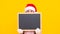 merry christmas. kid in santa hat behind blackboard for copy space. teen girl in mittens
