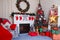 Merry Christmas living room interior with decorated fir-tree, fireplace, wreath, star, cones, bulbs, gift boxes and red plaid