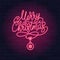 Merry Christmas red neon light sign on a brick wall dark background. Merry Christmas calligraphic greeting design.