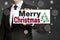 Merry Christmas signboard is held by businessman