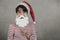 Merry Christmas,smiling kid Wearing Christmas Santa Claus hat with false beard on stick