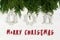 Merry christmas text sign on simple toys on green tree branches