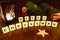 Merry Christmas words with flashlight candle, star, pine branch, cinnamon and orange