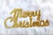 Merry christmas written in gold on white fur