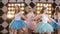 A merry group of young girls dancing around the bride, celebrating hen party - festive video in studio at the background