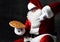 Merry laughing Santa Claus is pointing at big tasty pizza he is holding on his open palm. New year and Merry Christmas