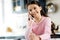 Merry optimistic girl calling mom with phone