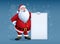 Merry Santa Claus standing with christmas greetings banner in arm