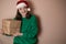Merry surprised young woman wear xmas sweater Santa hat posing pointing hands arms aside indicate on workspace area isolated on