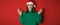 Merry surprised young woman wear xmas sweater Santa hat posing pointing hands arms aside indicate on workspace area isolated on