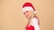 Merry young woman in a red Santa hat