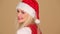 Merry young woman in a red Santa hat