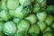 Mesh bags with fresh cabbages at market