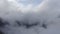 Mesmerizing aerial view of dense white clouds covering mountains